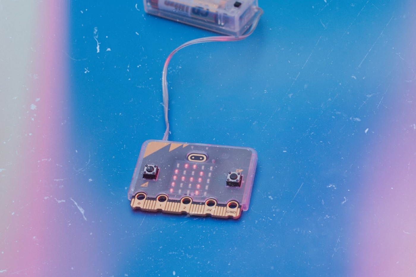 A BBC micro:bit pocket computer connected to its battery pack